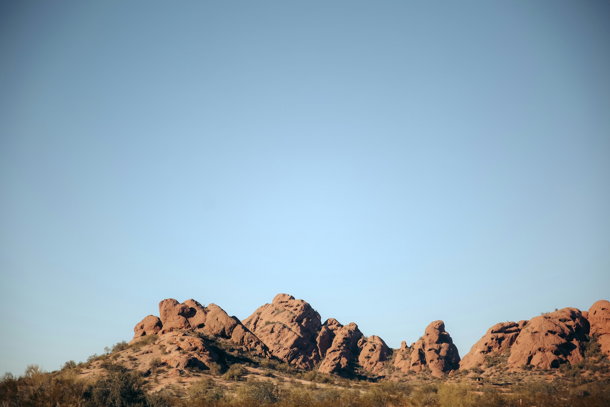 Red rock buttes of Papago Park under a wide blue Arizona sky